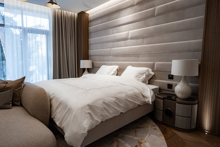 Contemporary bedroom with king bed and suede headboard panelsの写真素材