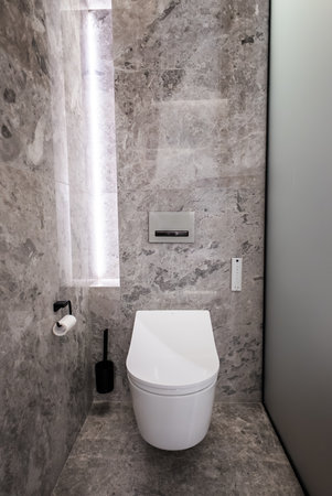 Modern marble alcove powder room with wall hung smart toiletの写真素材