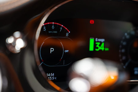 Luxury car digital cluster with tachometer, Park, and 34 km range