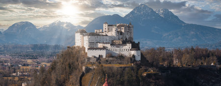 Hohensalzburg Fortress above Festungsberg with Alps in Salzburg