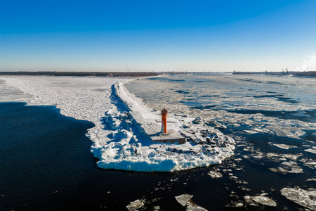 Aerial winter view of frozen Mangalsala Lighthouse in Riga, Latviaの写真素材