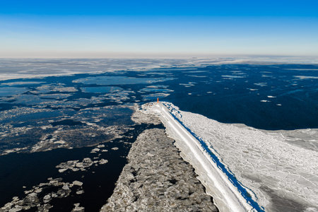 Aerial view of frozen Mangalsala Lighthouse in Riga, Latviaの写真素材
