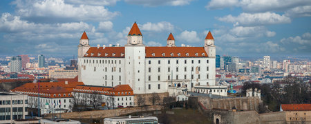 Bratislava Castle towers over the city skyline under a bright skyの写真素材
