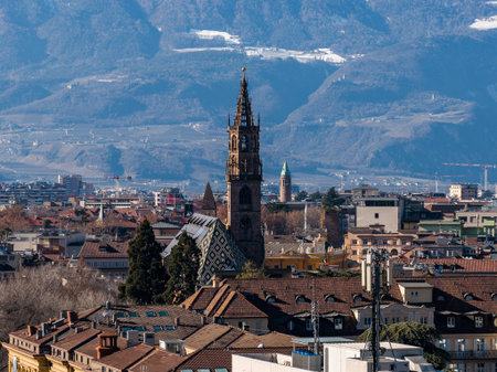 Bolzano Cathedral and historic center with alpine foothills in winterの写真素材