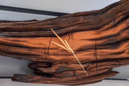 Wall mounted driftwood clock with Roman numerals in the Dolomites