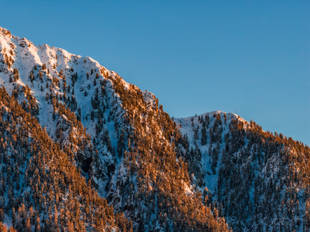 Dolomite Mountains, Italy, snow dusted peaks glow in warm alpenglow
