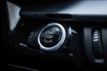 Start stop engine button on glossy black center console