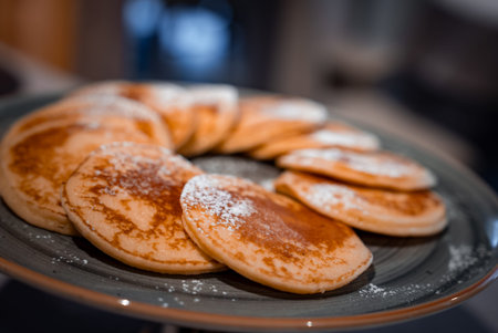 Ring of golden brown pancakes on grey plate in San Domenico, Italy