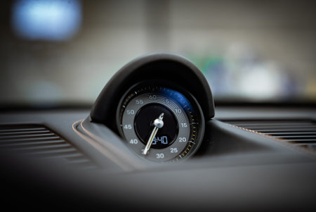 Porsche 911 GT3 Touring Sport Chrono gauge in workshop bokeh