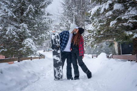 San Domenico ski resort couple kissing on snowy fir lined pathの写真素材