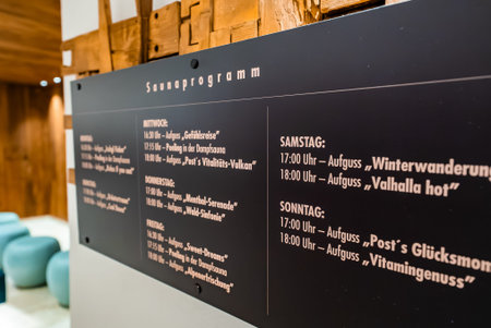 Saunaprogramm board lists Aufguss rituals in alpine spa interior