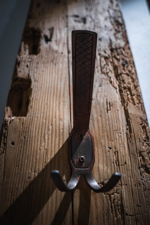 Wrought iron coat hook on reclaimed wood in Dolomites hotel