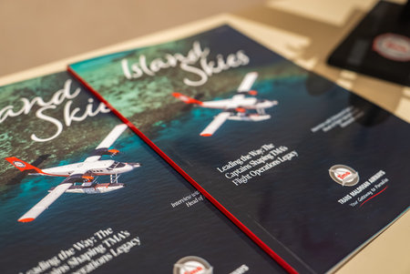 Magazines with Maldivian seaplane cover and TMA badge on table
