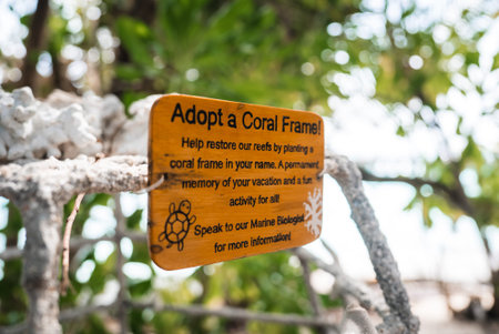 Maldives resort sign invites guests to adopt a coral frame program