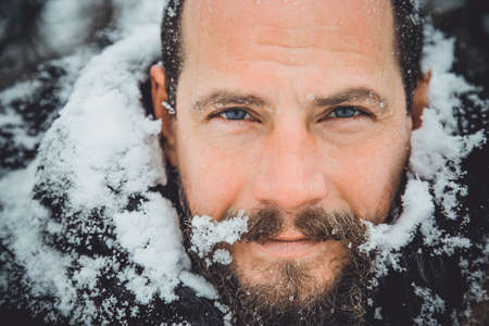 Portrait of a young handsome man with a beard. A person close up of a bearded man. Face full face...