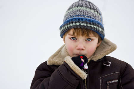 Portrait of a little boy with a lollipop.の写真素材