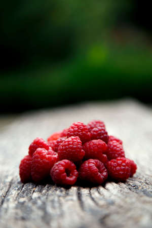 Fresh organic red raspberries. Composition with non-gmo red raspberries on the table. The concept of...