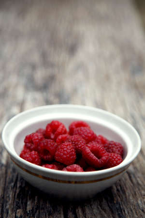 Fresh organic red raspberries. Composition with non-gmo red raspberries on the table. The concept of...