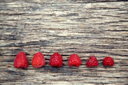 Fresh organic red raspberries. Composition with non-gmo red raspberries on the table. The concept of health, non-gmo products, clean ecological food.の写真素材