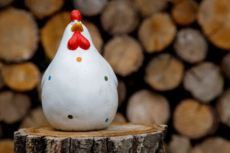 Clay figurine of a chicken on different backgrounds. Handmade clay white chicken. The concept of...