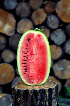 Juicy fresh red watermelon on the table. Watermelon sliced into pieces on a wooden texture background. The concept of food, happiness, sweets and desserts.の写真素材