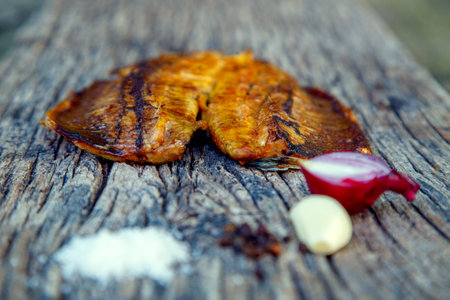 Sea fish cooked on the barbecue. Sea fish fillet baked on the grill. The concept of folk cuisine, restaurant, cooking.の写真素材