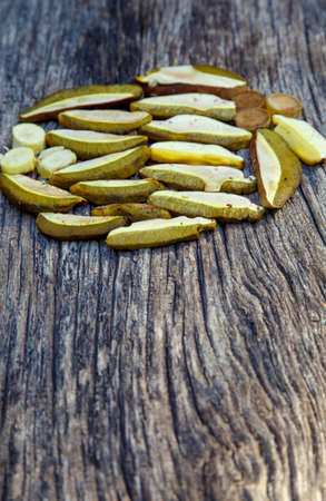 Sliced porcini mushrooms before drying. Sliced dried natural porcini mushrooms on a wood background....