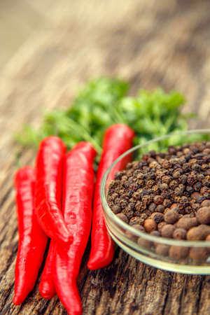 Red chili peppers on the table. Composition of red chili peppers and other spices. The concept of...