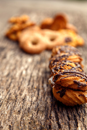 Fresh homemade biscuits in stock. Sweet cookies on a wooden table. Dessert sweet biscuits for tea and coffee. Concept of yummy, cookies, desserts.の写真素材
