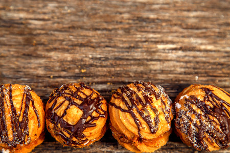 Fresh homemade biscuits in stock. Sweet cookies on a wooden table. Dessert sweet biscuits for tea and coffee. Concept of yummy, cookies, desserts.の写真素材