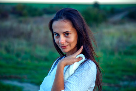 Young happy woman outdoors in autumn. Portrait of a girl's face on a walk in the park. The concept of happiness, freedom, outdoor recreation.の写真素材