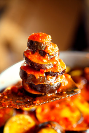 Eggplants with vegetables stewed in tomato sauce. Homemade vegetarian cuisine. Stewed vegetables from fresh home-grown products.の写真素材