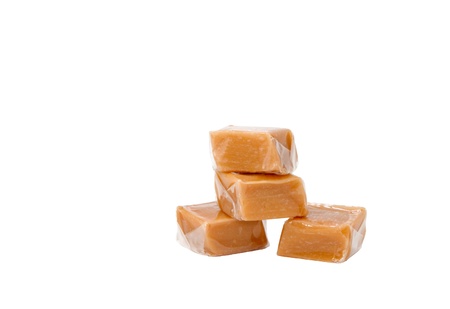 Caramel sweets in plastic wrap, isolated on white backgroundの写真素材