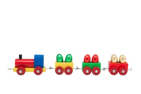Colorful wooden model railway with Easter eggs on goods waggons, isolatedの写真素材