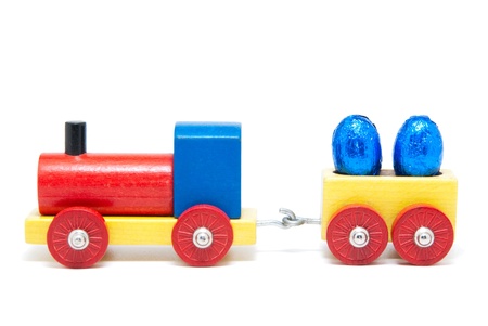 Colorful wooden model railway with Easter eggs on goods waggons, isolatedの写真素材