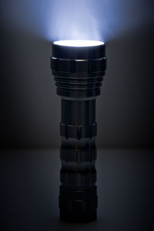 Small flashlight and beam in the dark.の写真素材