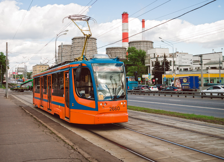 Public urban transport. Orange tram on the city street.のeditorial素材