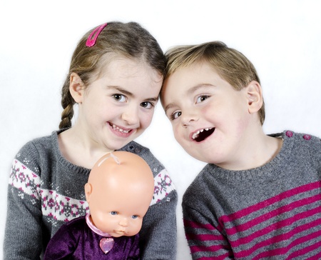 Portrait of a child, the love of brother and sister in his arms on a white backgroundの写真素材