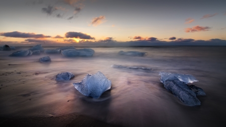 Blocks of ice float in a Jokursarlon beach in south Iceland.の写真素材