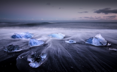 Blocks of ice float in a Jokursarlon beach in south Iceland.の写真素材