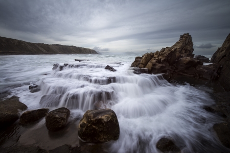 Little falls in the beach of Azkorri, Spainの写真素材