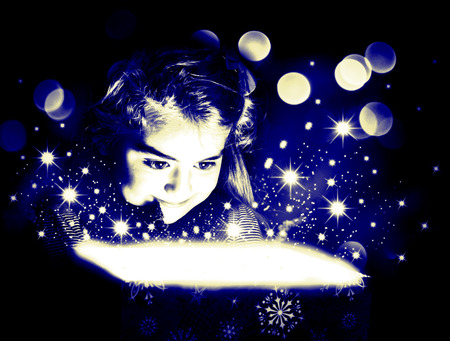 Child opening a magic gift box with lights and shining aroundのeditorial素材