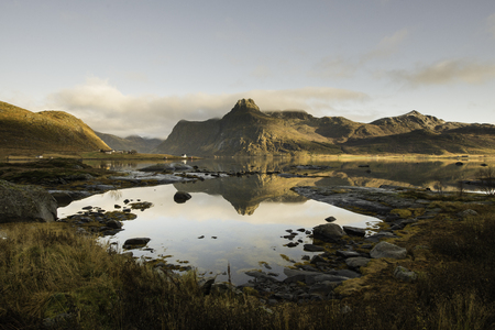Lake with wooden cabins in the shore, Lofoten islands, Norway in a sunny dayの写真素材