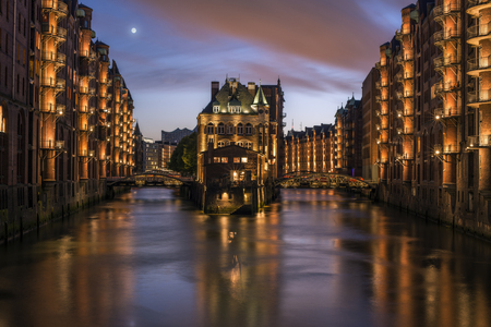 Full moon at sunset over the canals of Hamburg, Germanyの写真素材
