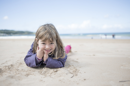 Little girl at the beach in winterの写真素材