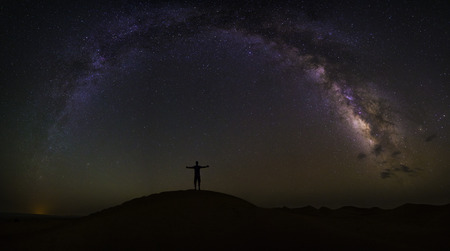 Milky Way arch over the desert of Chigaga, Moroccoの写真素材