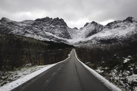 Lone mountain road in winter, Lofoten islands, Norwayの写真素材