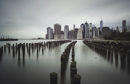Mnahattan skyline from a Brooklyn`s shore old wooden pierの写真素材