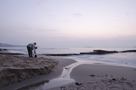 Photographer takes pictures panorama of the sea seasideの写真素材