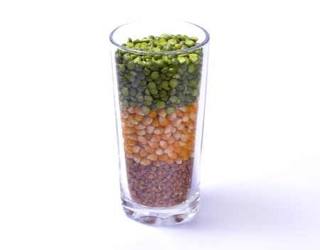 Peas, corn, buckwheat in a glass layer on a white background isolated